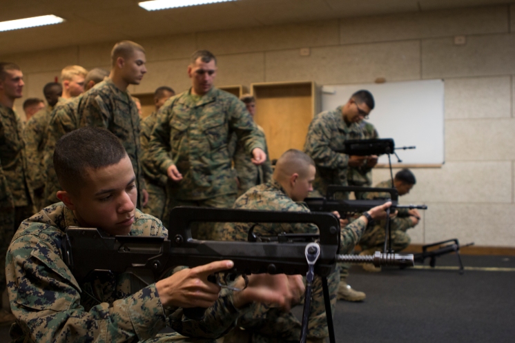 US Marines and French Gendarmie inspect weapons as part of a 2014 training exercise. US Marines and French Gendarmerie exercise